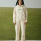 OFF-WHITE SWEATPANTS WITH GREEN EMBROIDERY
