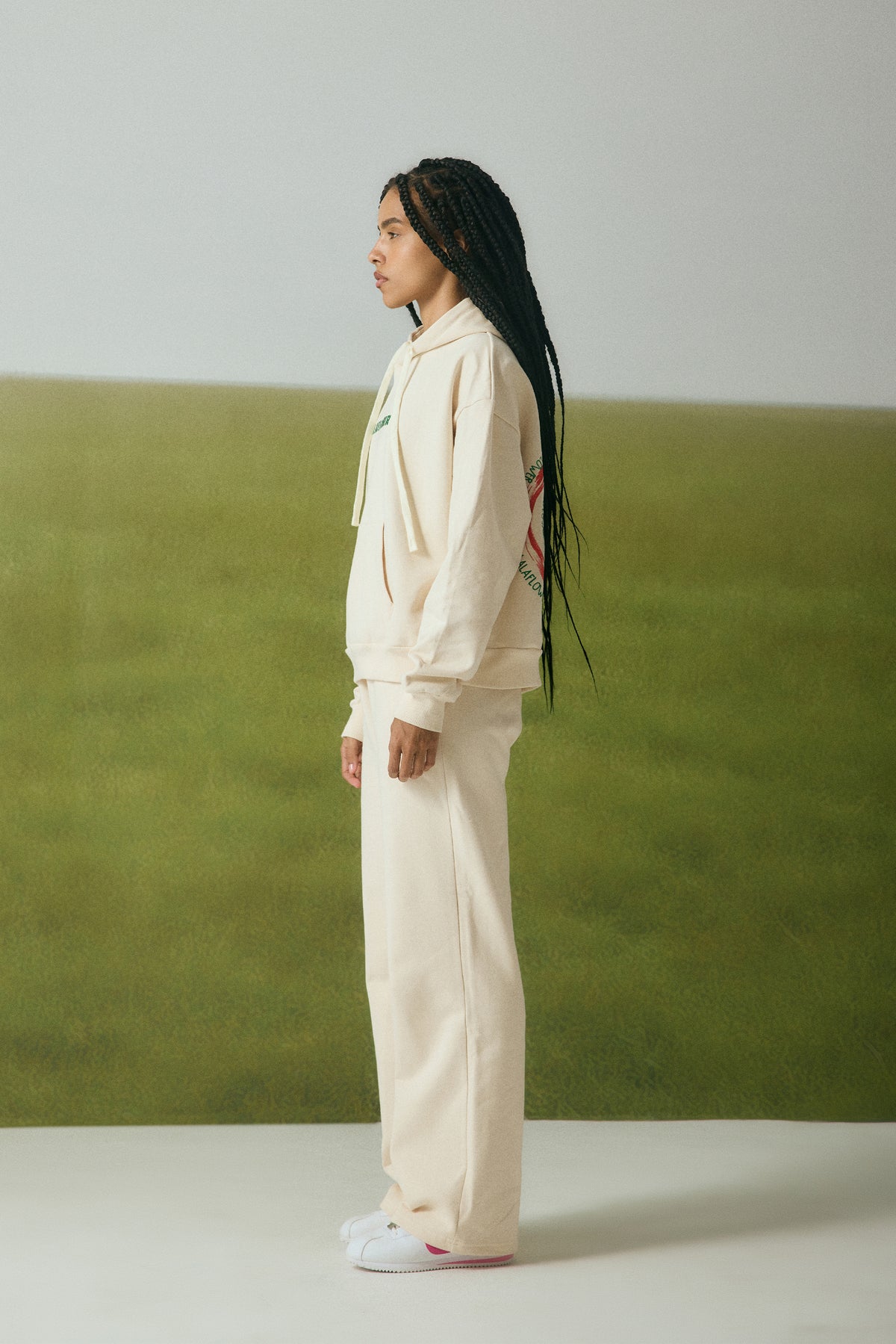 OFF-WHITE SWEATPANTS WITH GREEN EMBROIDERY