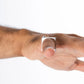 MAISON MEGH Edge Ring with sparkling gems, silver-tone jewelry featuring a modern, sleek design with gemstone accents.