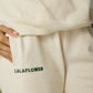 OFF-WHITE SWEATPANTS WITH GREEN EMBROIDERY