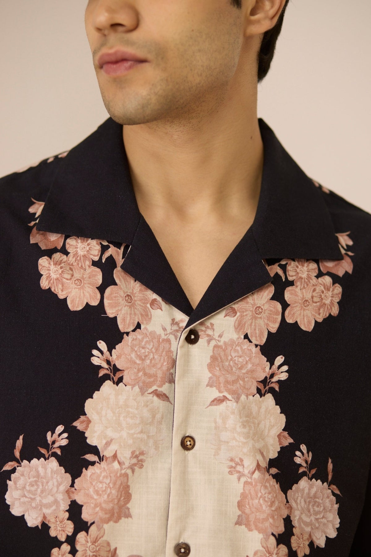Man wearing a floral patterned shirt with a neutral background Calling June