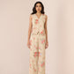 Woman wearing a floral outfit on a beige background Calling June