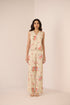 Woman wearing a floral outfit on a beige background Calling June