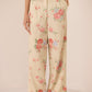 Floral patterned pants on a plain background Calling June