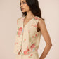 Woman wearing a floral outfit against a plain background Calling June