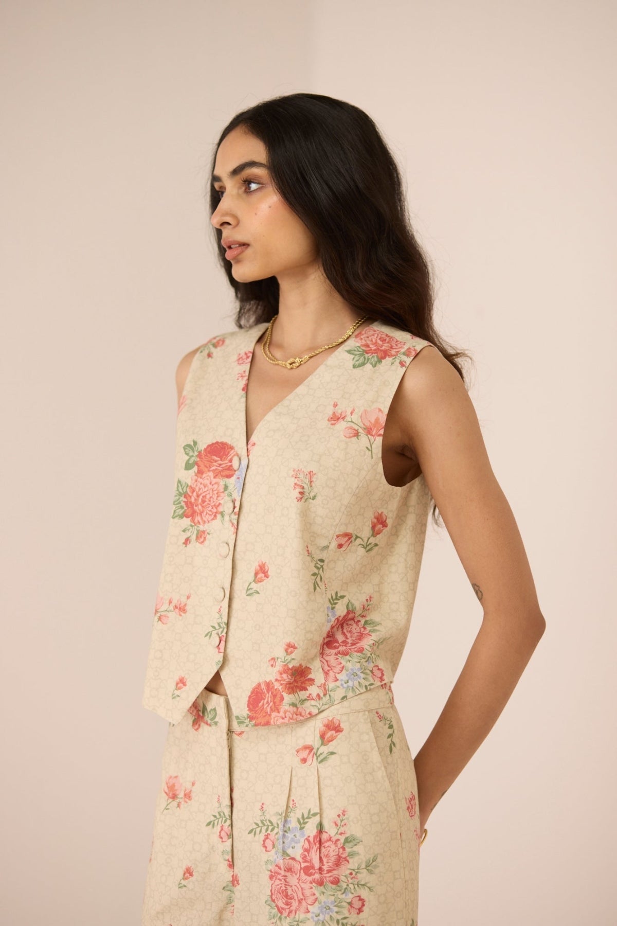 Woman wearing a floral outfit against a plain background Calling June