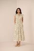 Woman wearing a floral dress against a plain background Calling June