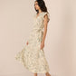 Woman wearing a floral dress on a beige background Calling June