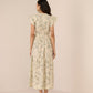 Woman wearing a floral dress against a beige background Calling June