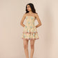 Woman wearing a patterned dress against a plain background Calling June