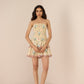 Woman wearing a strapless floral dress against a beige background Calling June