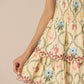Yellow dress with floral embroidery on a beige background Calling June