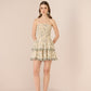 Woman wearing a strapless floral dress on a beige background Calling June