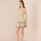 Woman wearing a strapless floral dress on a beige background Calling June