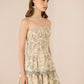 Woman wearing a strapless floral dress against a beige background Calling June