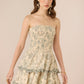 Woman wearing a strapless floral dress against a beige background Calling June