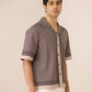 Man wearing a patterned shirt with a plain background Calling June