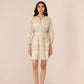 Woman wearing a light-colored dress with a subtle pattern on a beige background Calling June