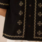 Black embroidered shirt with beige patterns on a neutral background Calling June