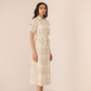 Woman wearing a patterned dress on a plain background Calling June