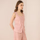 Woman wearing a pink striped outfit on a beige background Calling June