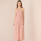 Woman wearing a pink strapless dress against a plain background Calling June