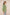 Woman wearing a green embroidered blouse against a beige background Calling June