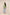 Woman wearing a green embroidered top and light blue jeans on a beige background Calling June