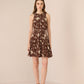 Woman wearing a brown floral dress against a beige background Calling June