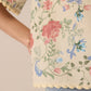 Floral patterned fabric with pink roses and green leaves on a beige background Calling June