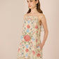 Woman wearing a floral dress against a beige background Calling June