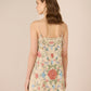 Woman wearing a floral dress with a beige background Calling June