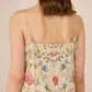 Woman wearing a floral dress with thin straps on a beige background Calling June