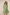 Woman wearing a green dress with embroidery on a beige background Calling June