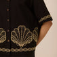 Black shirt with gold embroidery on a plain background Calling June