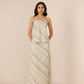 Woman wearing a strapless, long, patterned dress against a plain background Calling June