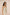 Woman wearing a strapless outfit with a striped top against a beige background Calling June