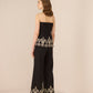 Black strapless top and pants with gold embroidery on a beige background Calling June