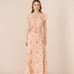 Woman wearing a floral dress on a beige background Calling June