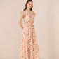 Woman wearing a floral dress on a beige background Calling June