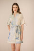 Woman wearing a patterned dress with a neutral background Calling June