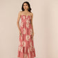 Woman wearing a pink strapless dress with floral pattern on a beige background Calling June