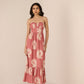 Woman wearing a pink strapless dress with floral pattern on a beige background Calling June