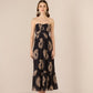 Woman wearing a strapless dress with floral pattern on a beige background Calling June