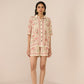 Woman wearing a floral outfit on a beige background Calling June