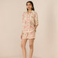 Woman wearing a floral dress with a beige background Calling June