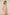 Woman wearing a floral outfit on a beige background Calling June