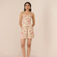 Woman wearing a floral dress with a plain background Calling June