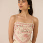 Woman wearing a floral dress with a beige background Calling June