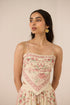 Woman wearing a floral dress with a beige background Calling June